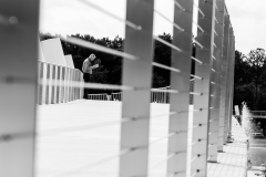 Man reading on walkway, BW Man reading on walkway, BW