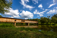 Reflecting covered bridge in water Reflecting covered bridge in water